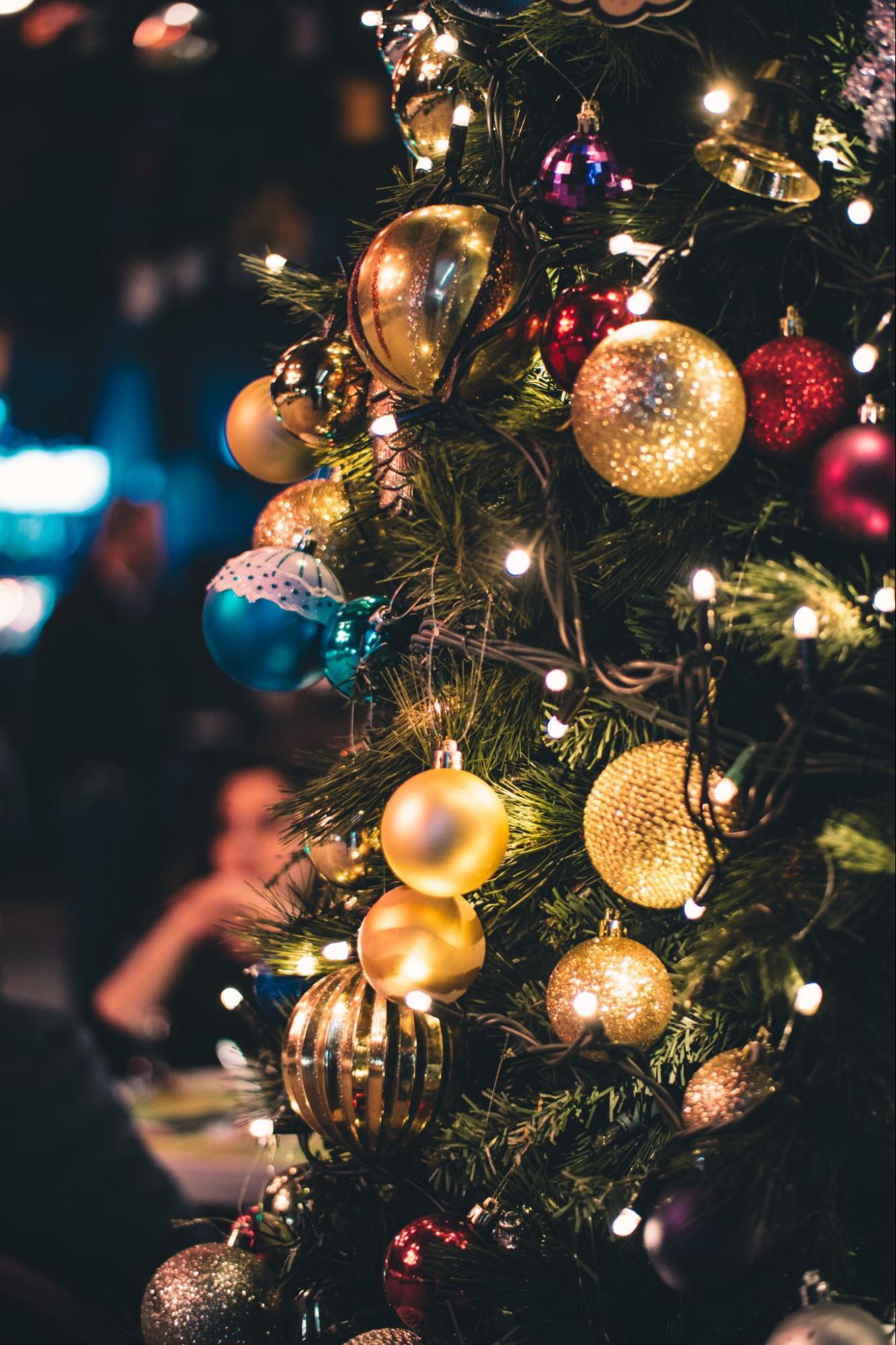 Close up of a tree decorated with golden ornaments and lights